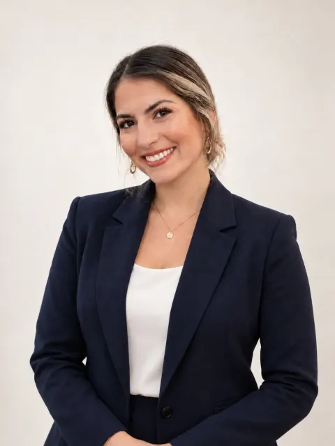 Portrait of Jana Infante, Ethos co-founder who leads design and client care, in a navy blazer