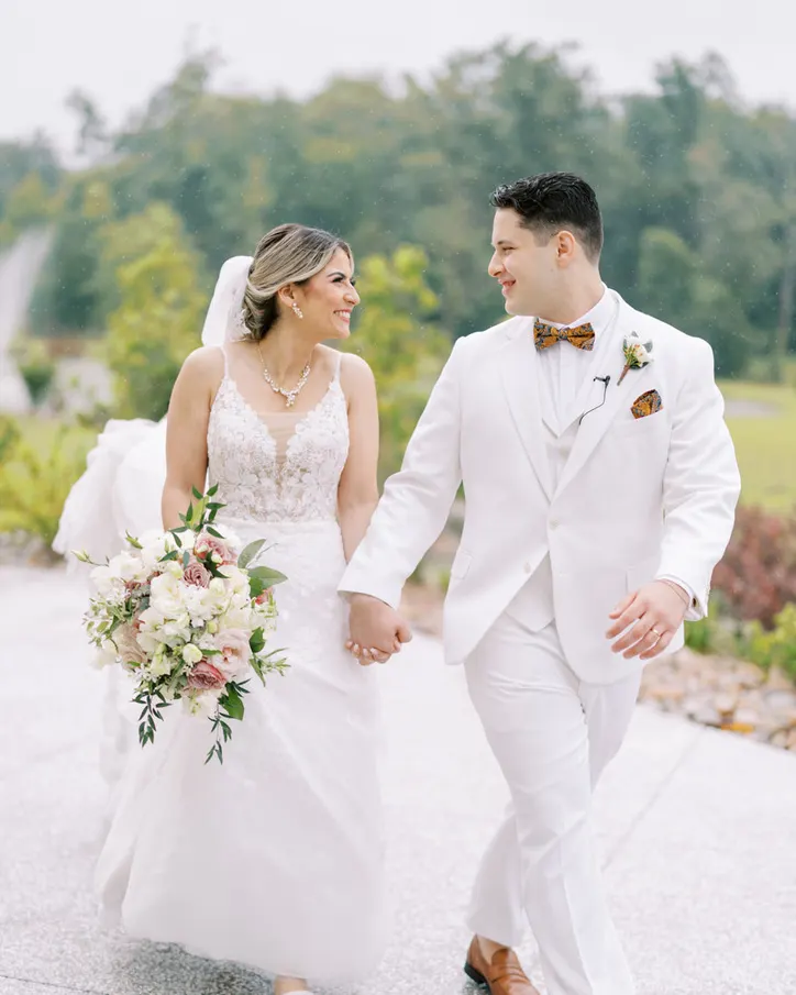JP and Jana Infante walking hand in hand on their wedding day